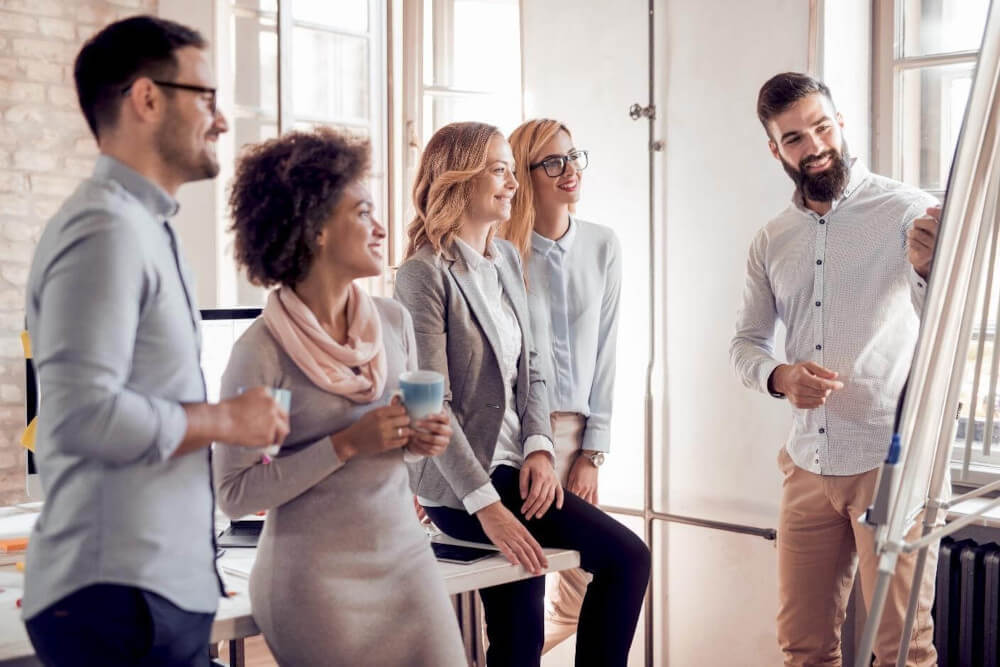 A group of people standing around each other.